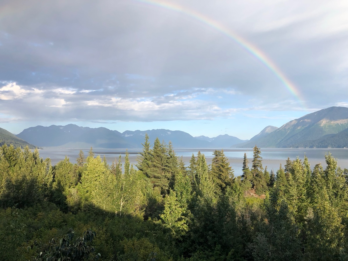 Beautiful Alaska landscape with rainbow over mountains and lake - Pure Maintenance serves all of Alaska